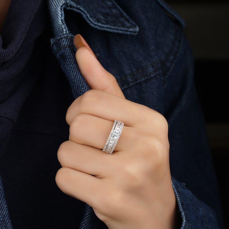 Person Wearing Silver Ring With Diamonds