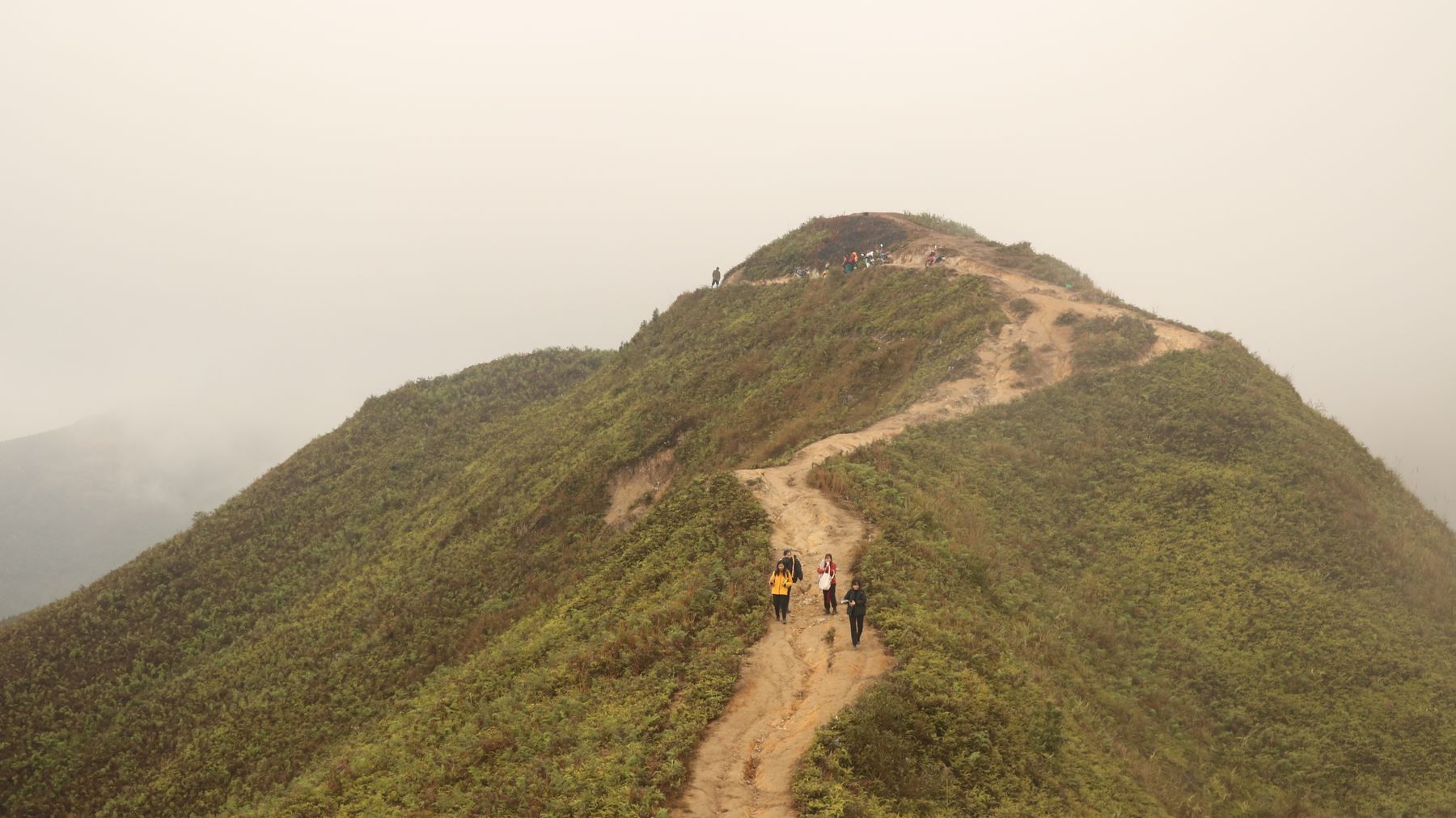 Aerial view of hikers on a mountain trail in Sơn La, Vietnam, showcasing natural beauty and adventure.
