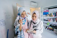 Two Women In White Hijab Veils