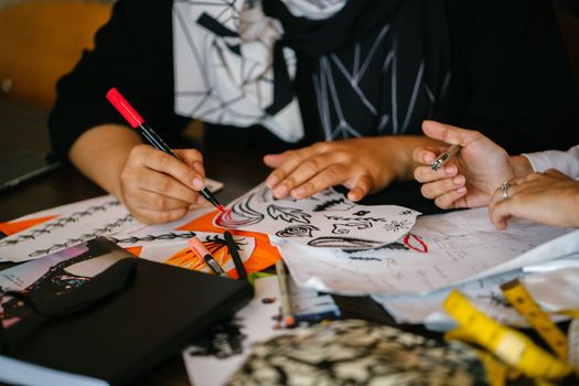 Person Writing on Paper on Top of Table