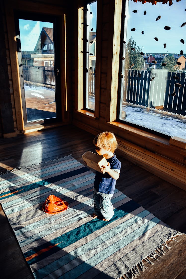 Little Boy Carrying A Box