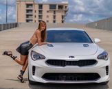 A Woman in a Trendy Outfit Leaning on a Car