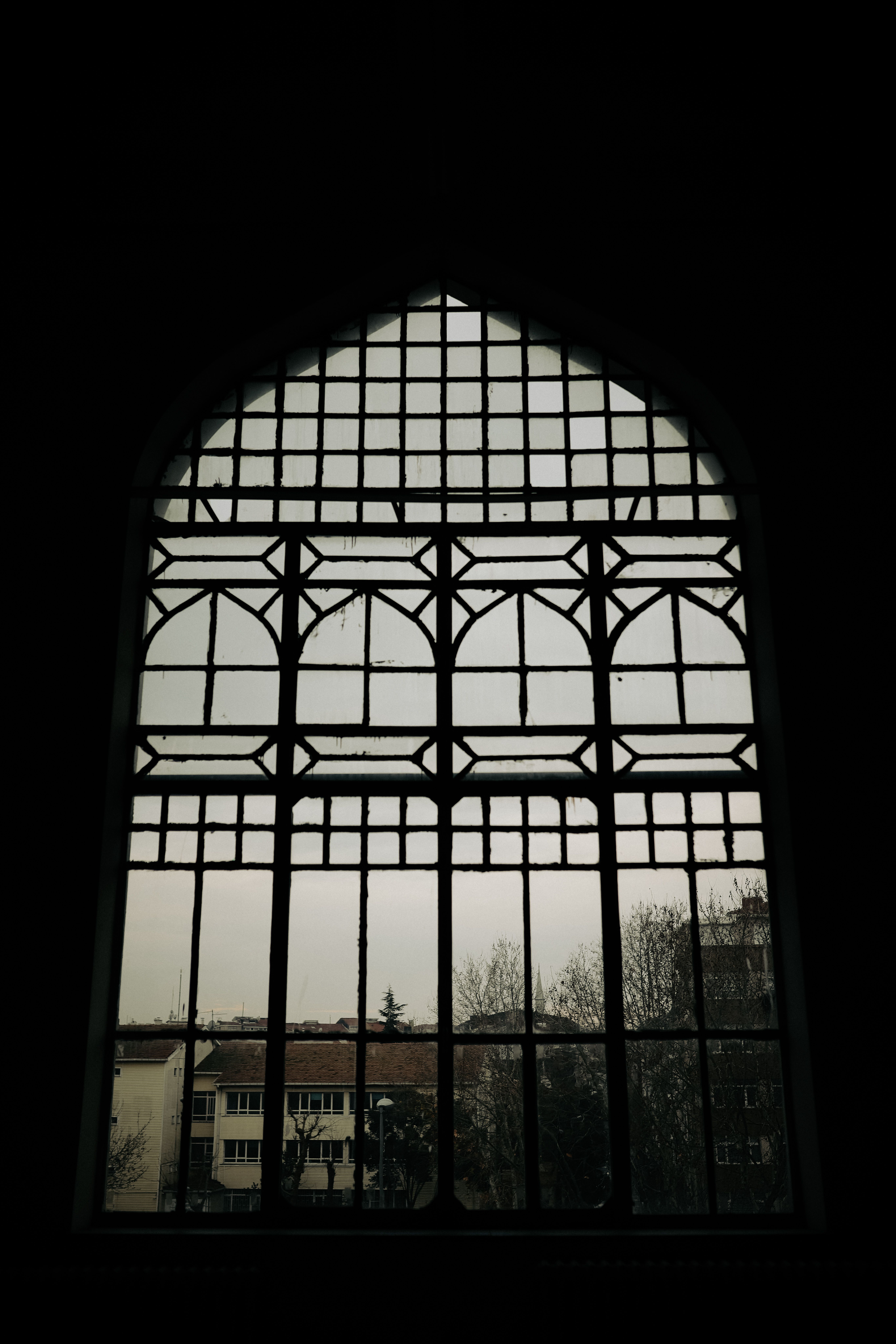 Silhouette of Person in an Arched Window · Free Stock Photo