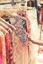 Shallow Focus Photography of Assorted-color Clothes Hanged on Clothes Rack