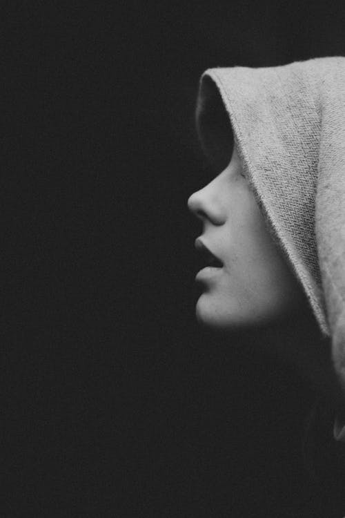 Black and White Photo of a Woman Wearing a Hoodie