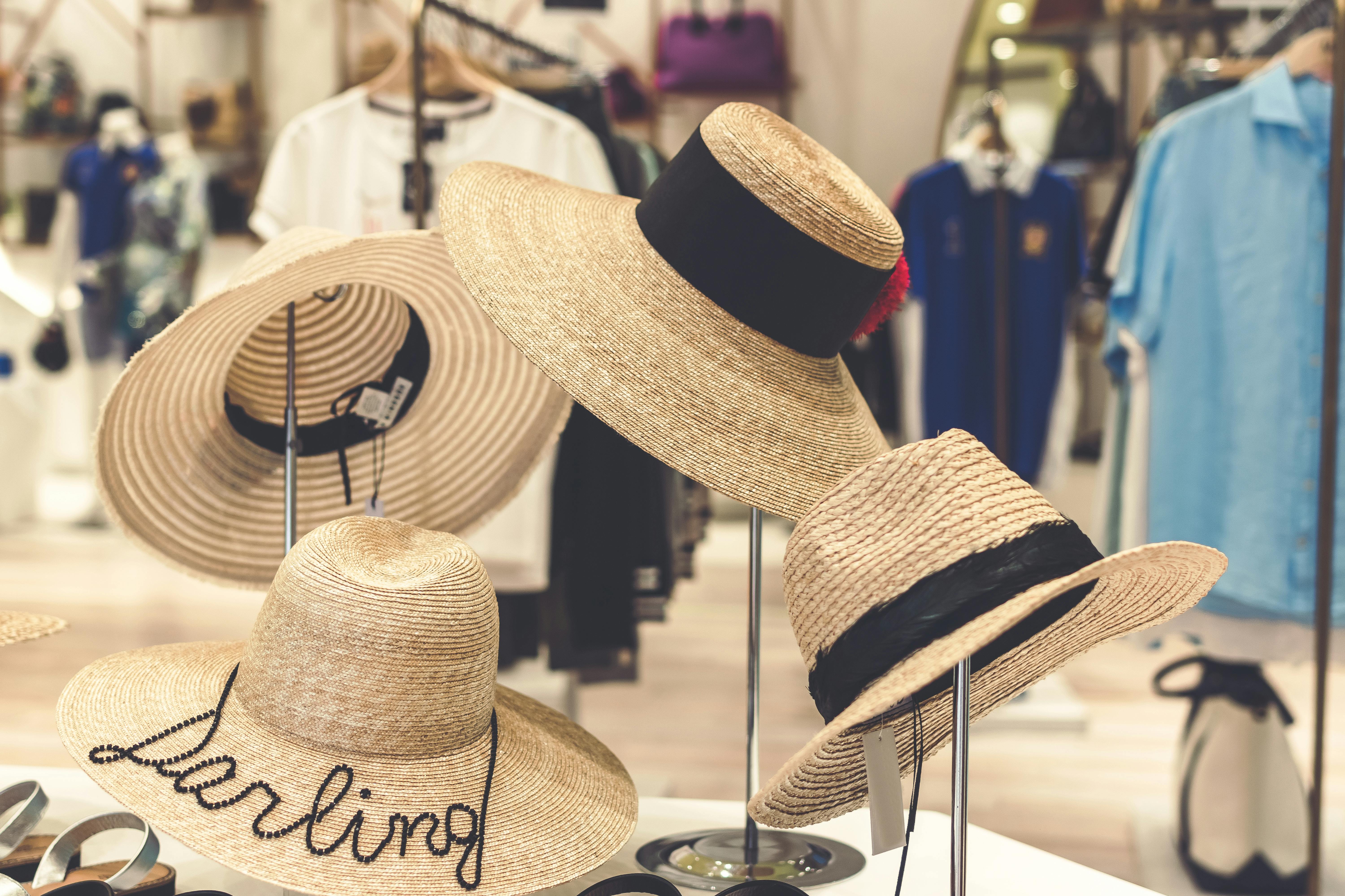 four brown straw hats display