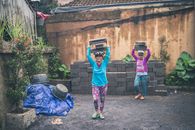 Photography of People Carrying Cinder Blocks