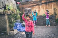 Photography of People Carrying Cinder Blocks