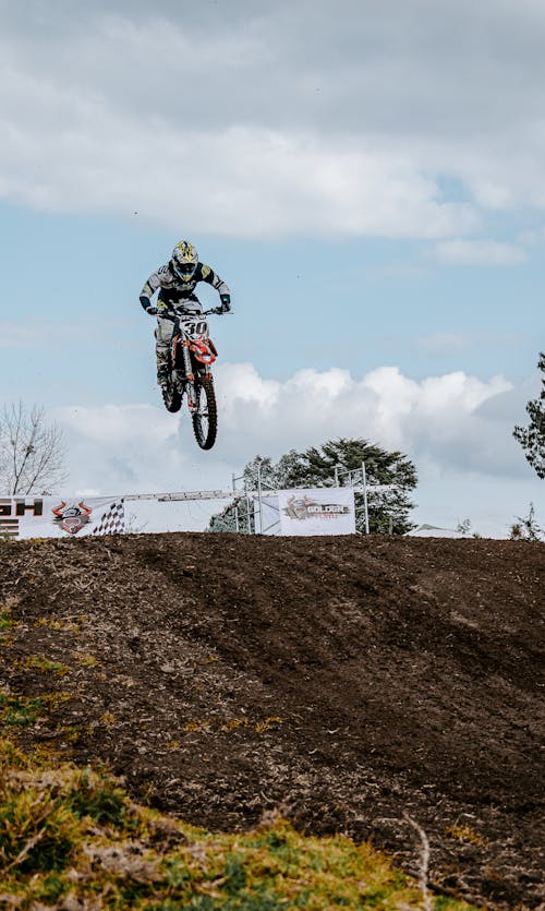 Man Riding a Dirt Bike Jumping on a Ramp