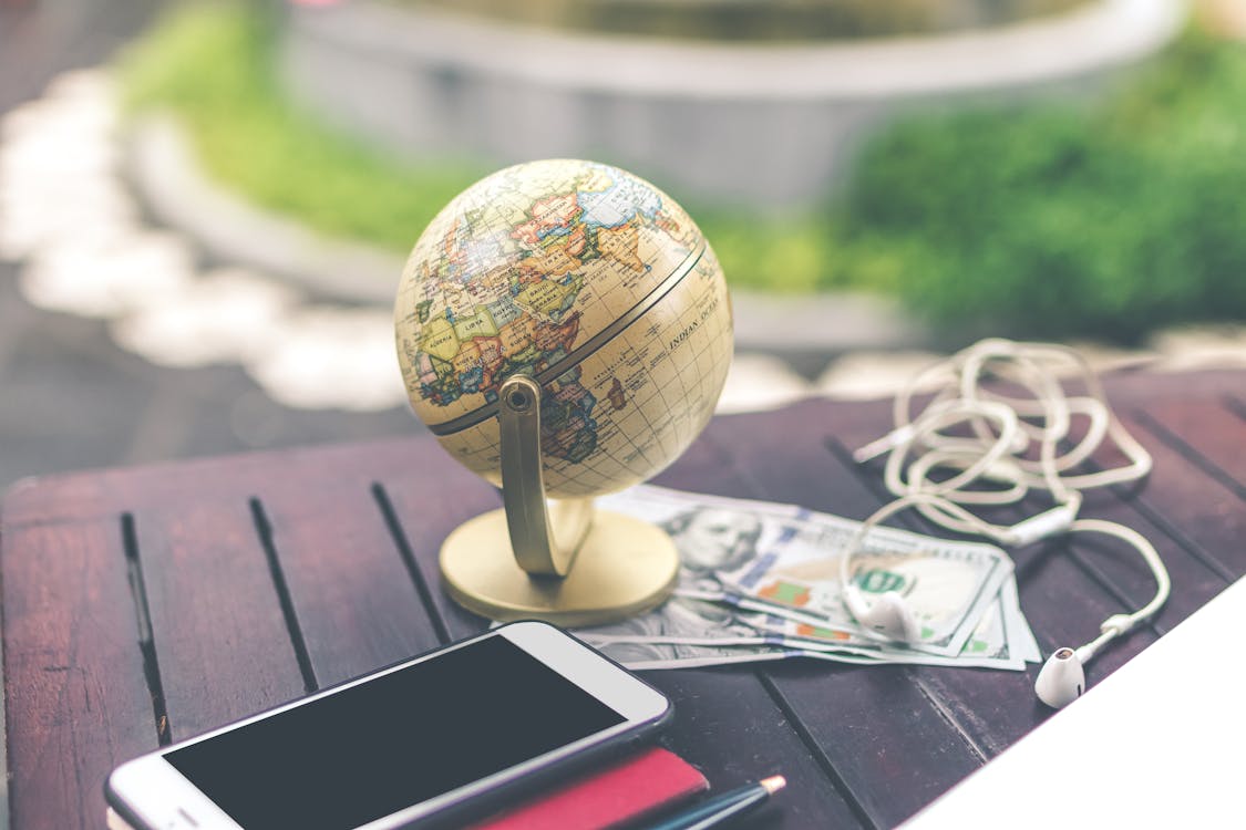 Smartphone Beside Mini Desk Globe