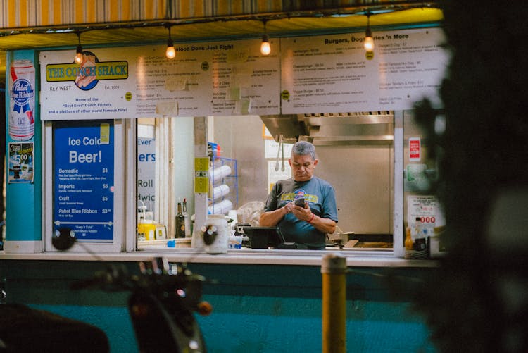 Man Using Phone Inside A Store 