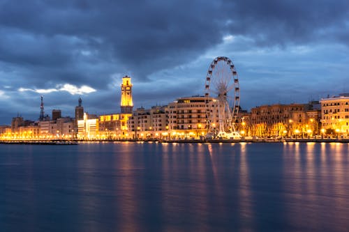 Ferris Wheel and Buildings Beside a River