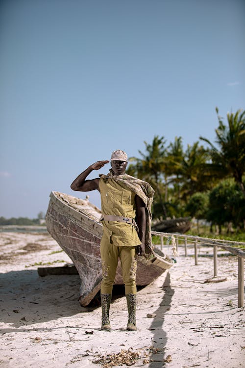 Soldier Saluting while Standing on Beach 