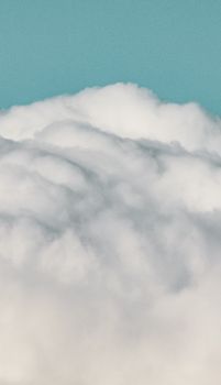 A serene view of fluffy white clouds with a clear blue sky in the background. Perfect for peaceful imagery.