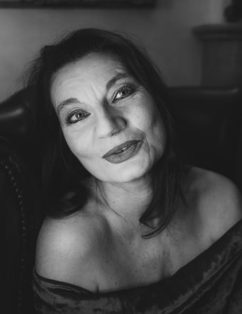 Grayscale Photo of Woman Smiling