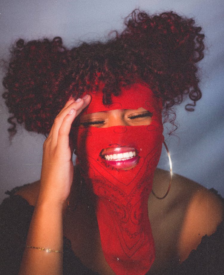 Smiling Woman With Red Bandana On Her Face 