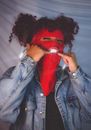 A Woman in a Ski Mask Bandana Pointing at her Grill