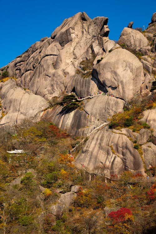 Rock Formation with Tourist Footpath and Autumn Trees