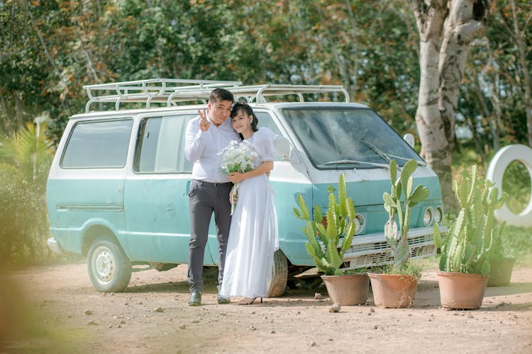 Man And Woman Standing Beside A Van