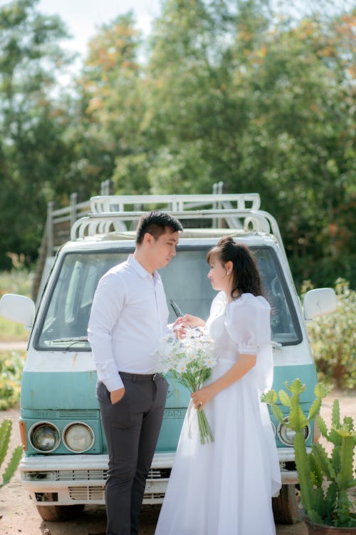 Free People in White Clothes Standing in Front of a Van Stock Photo