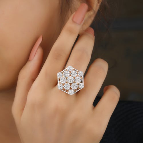 Close-Up Shot of a Person Wearing a Silver Diamond Ring