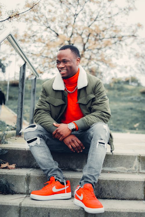 Man Wearing A Red Shirt Under His Jacket