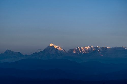Free Breathtaking view of snow-covered Himalayas during sunrise with clear blue sky. Stock Photo