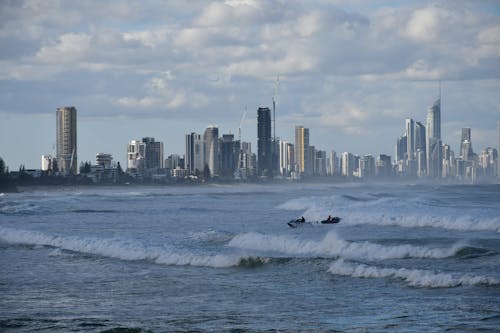 People Riding Speedboats on Ocean with Waves