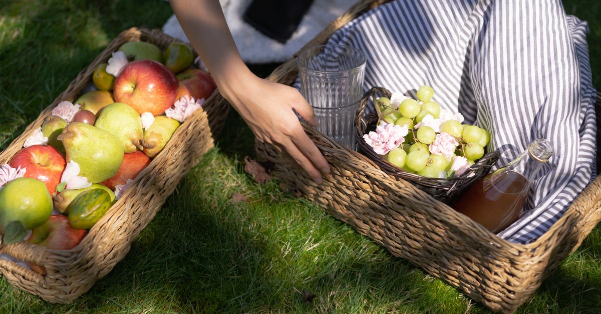close up of hands putting clutter into a stylish wicker basket