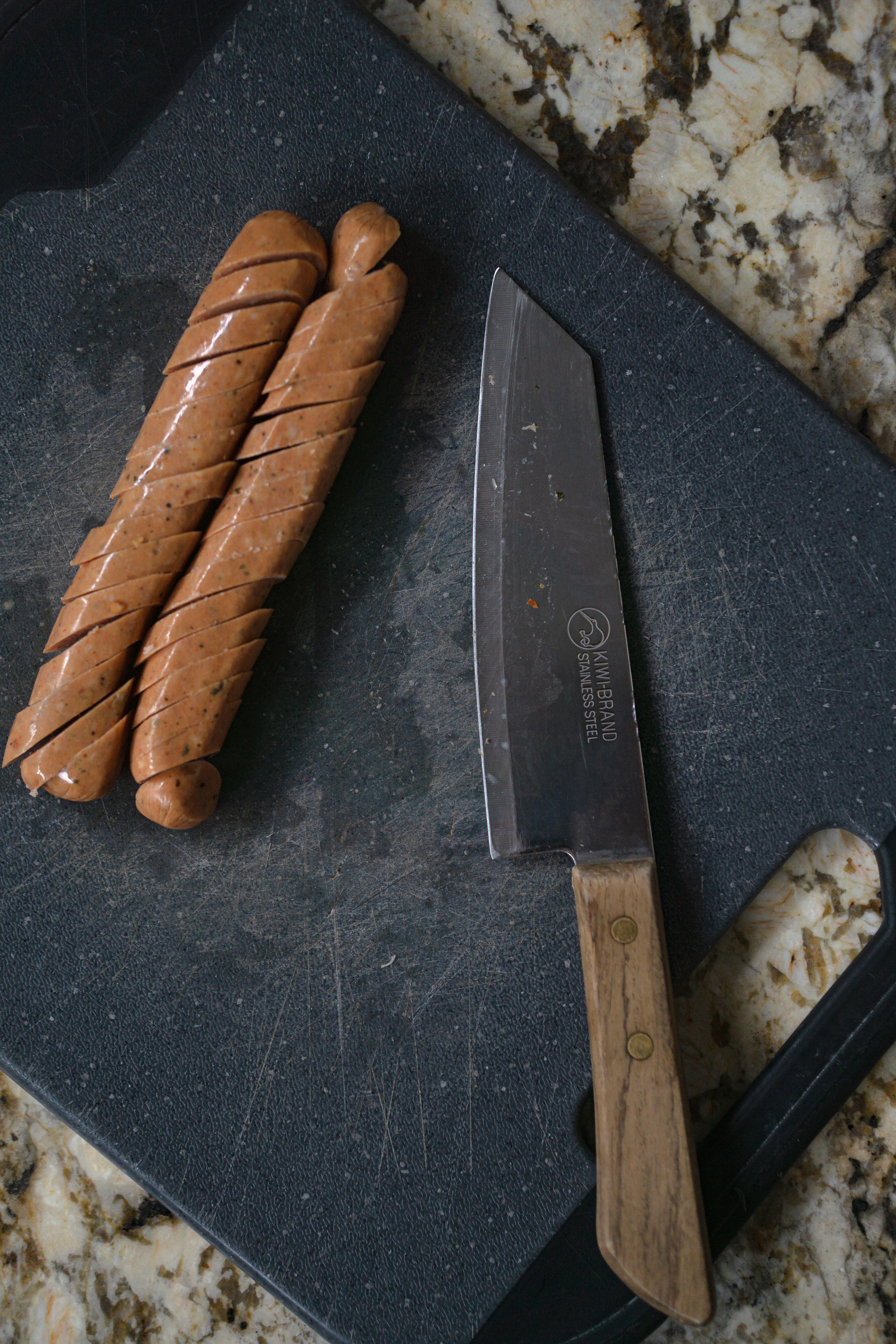 Thick coins of smoked Polish sausage browned in a cast iron skillet with onions and peppers