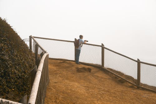 Free Man With Backpack Taking Picture  Stock Photo