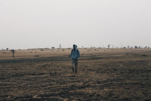 Man Walking Alone on Wasteland