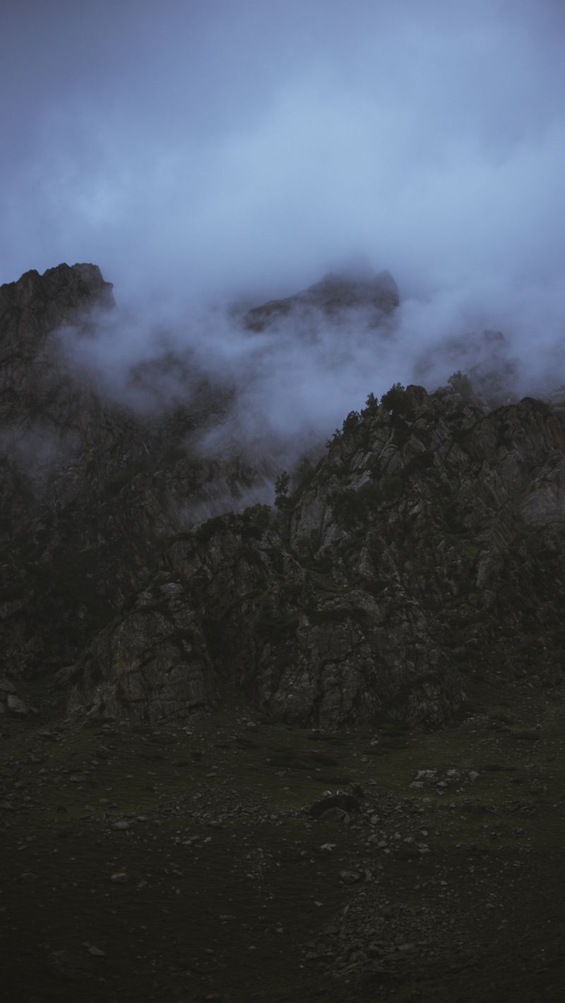 Mysterious rocky mountain peaks shrouded in mist at dawn — Sheikh Abrar Ul Haq on Pexels