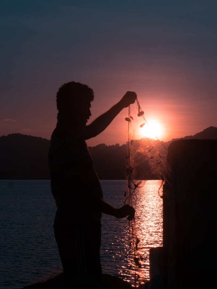 A Person Holding A Fishing Net