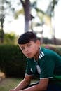 Young Boy Wearing a Green Shirt Posing