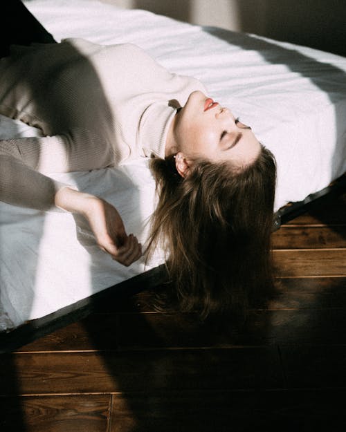 Woman Lying on the Bed with Shadow Falling on Her 