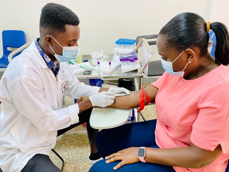 Man Injecting A Patient On Her Arm