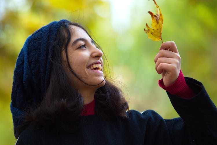 Teenage Girl Holding A Leaf