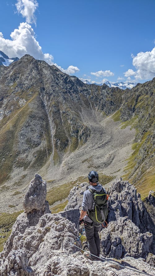 Man in Helmet Standing on Rocky Mountain