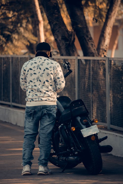 Man Standing Beside Motorcycle