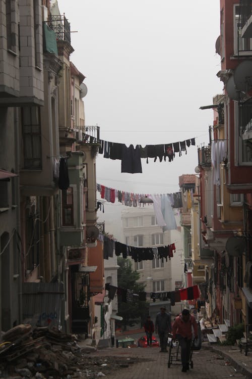 Clothes Hanging in between Concrete Buildings