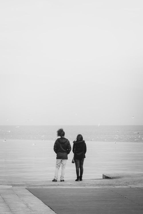 Free Two people standing by the sea in İzmir, enjoying a peaceful moment. Stock Photo