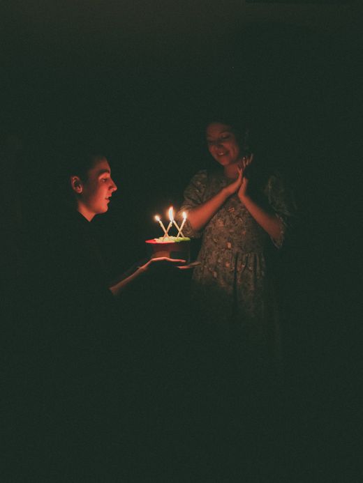 Two people in a dark room lit by candlelight — photo by Yana Bulgak on Pexels