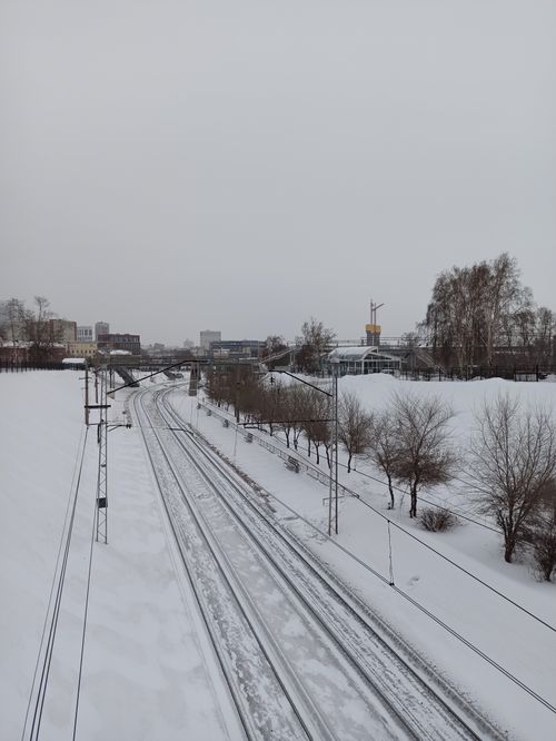 Free Snow-covered railway tracks in a winter cityscape of Novosibirsk, Russia. Stock Photo