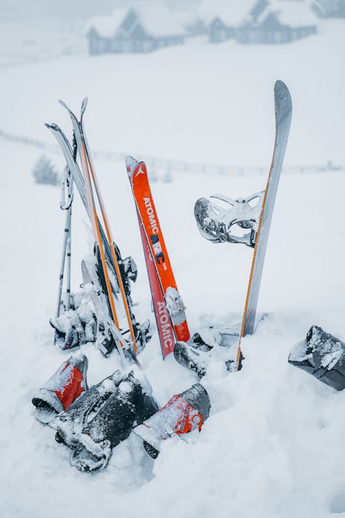Red and White Ski Blades on Snow Covered Ground