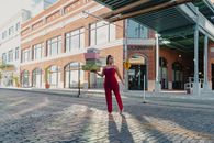 Woman in Red Dress Walking on Sidewalk