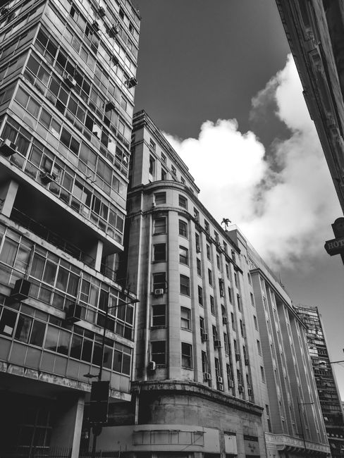 Black and white photo of downtown skyscrapers with dramatic clouds.