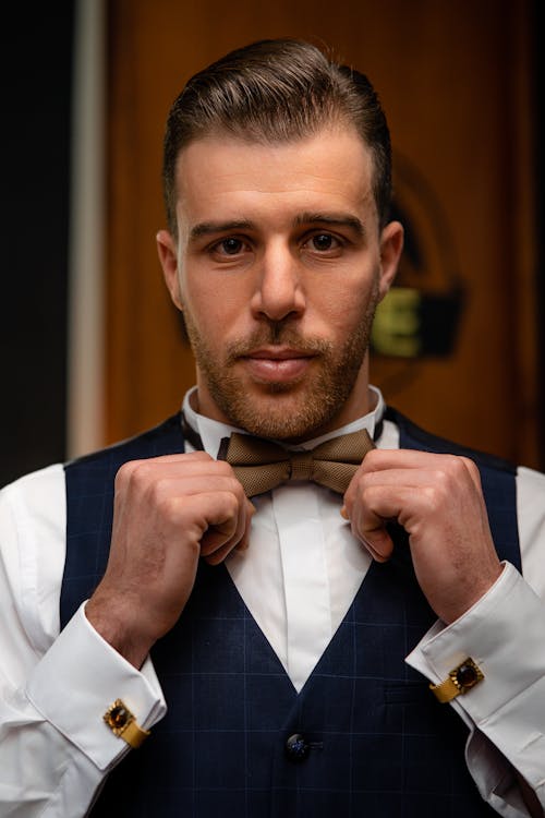 Handsome Man in Blue Vest and Brown Bow Tie 