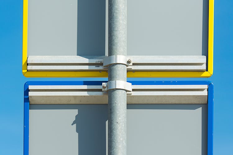 Road Signs Back Against Blue Sky