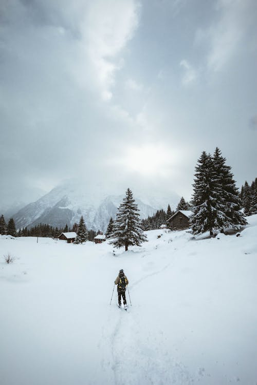 Free Person Hiking in Snowy Mountains  Stock Photo